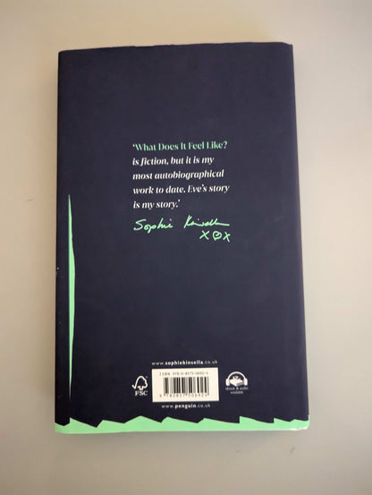 Back cover of What Does it Feel Like by Sophie Kinsella, showcasing the book's synopsis and secondhand condition, available at PrelovedLibrary.co.uk